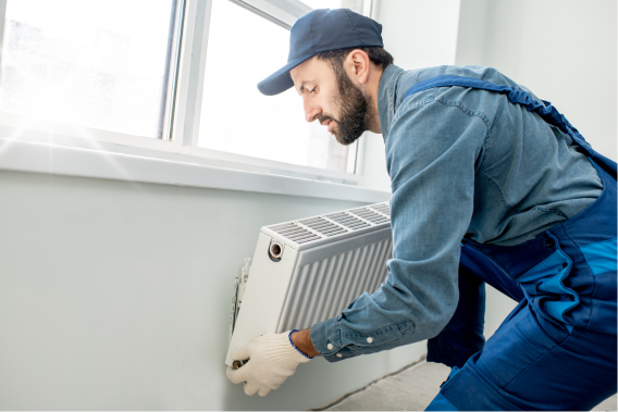 electrician fitting a brand new storage heater