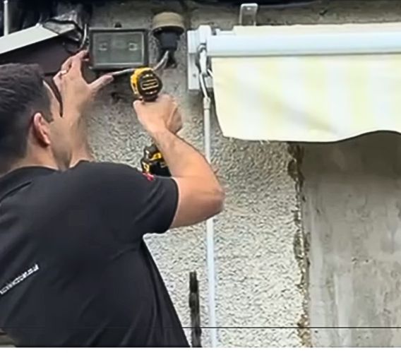Electrician installing floodlights